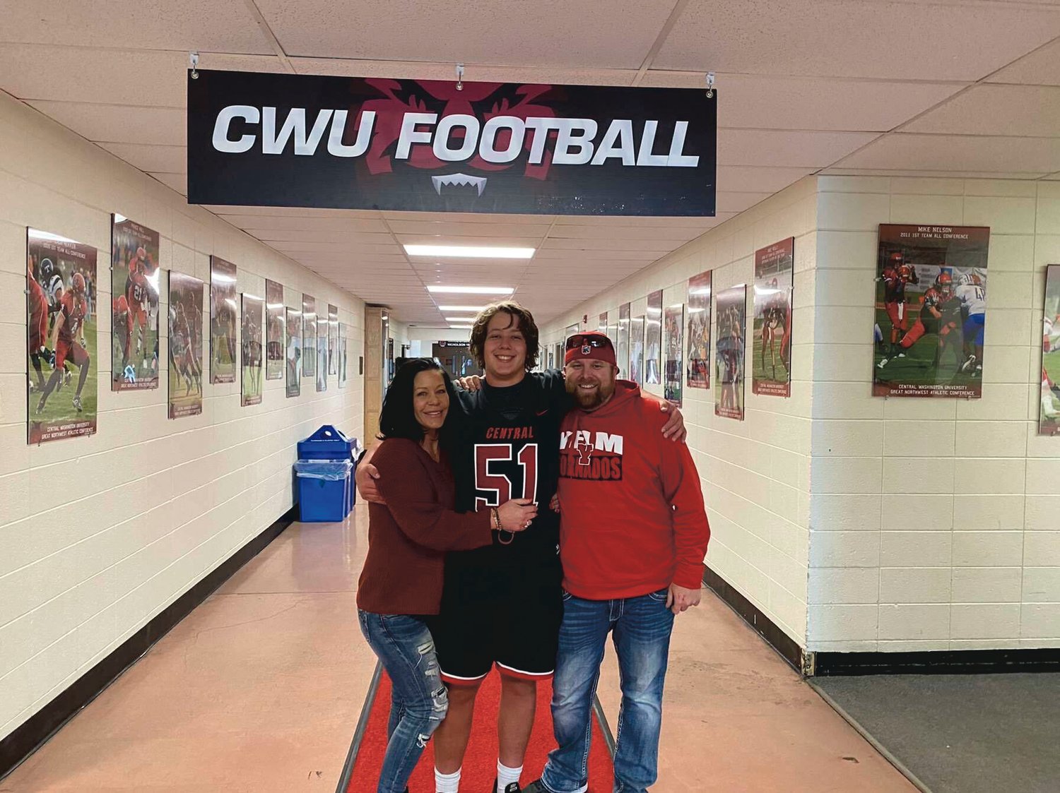 Slade Edwards poses with his parents during his official visit to Central Washington University.